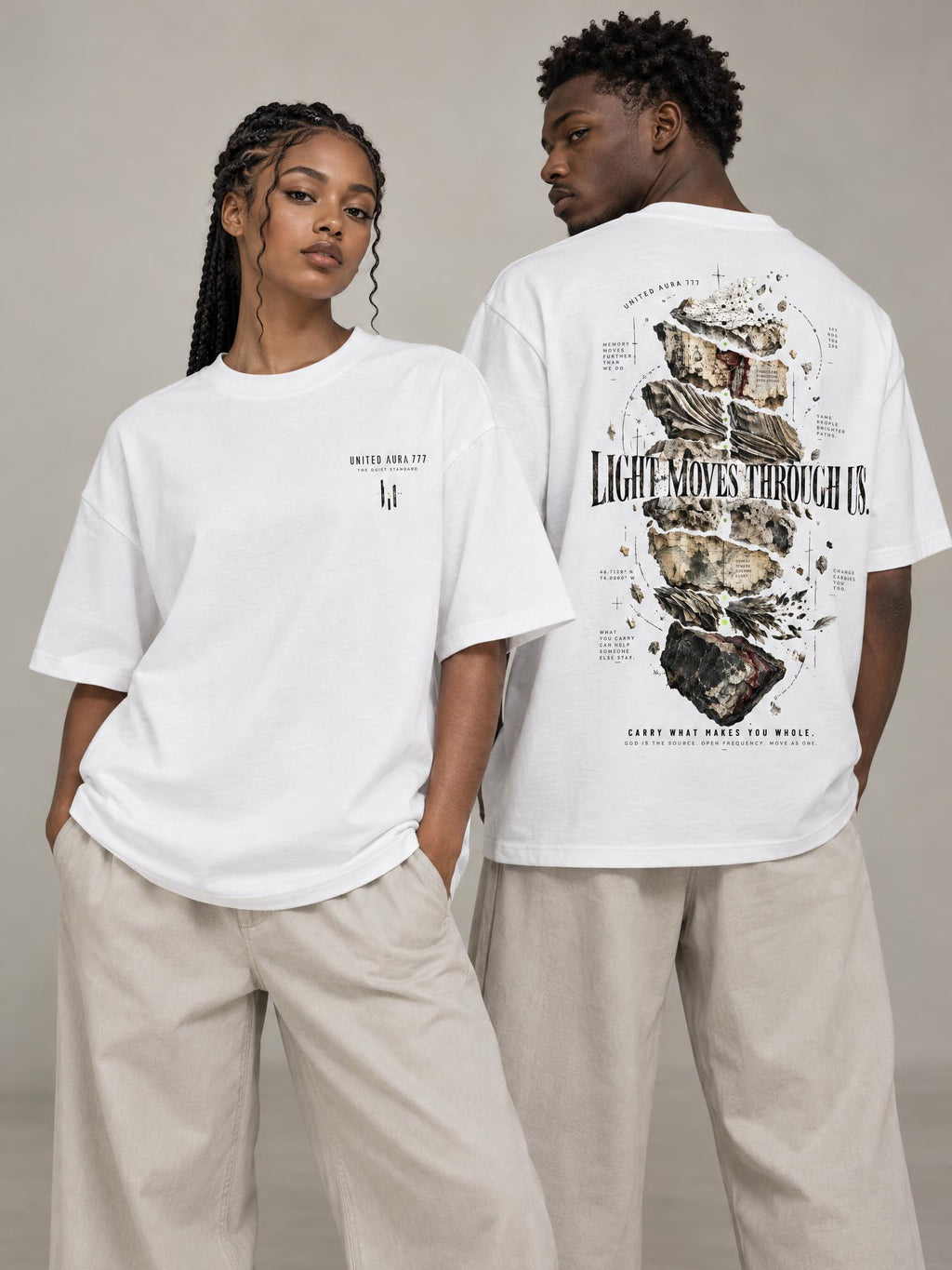 Two models wearing oversized white graphic T-shirts, one showing the front and the other showing the back. The back shirt features a large abstract graphic with the text 'LIGHT MOVES THROUGH IT.